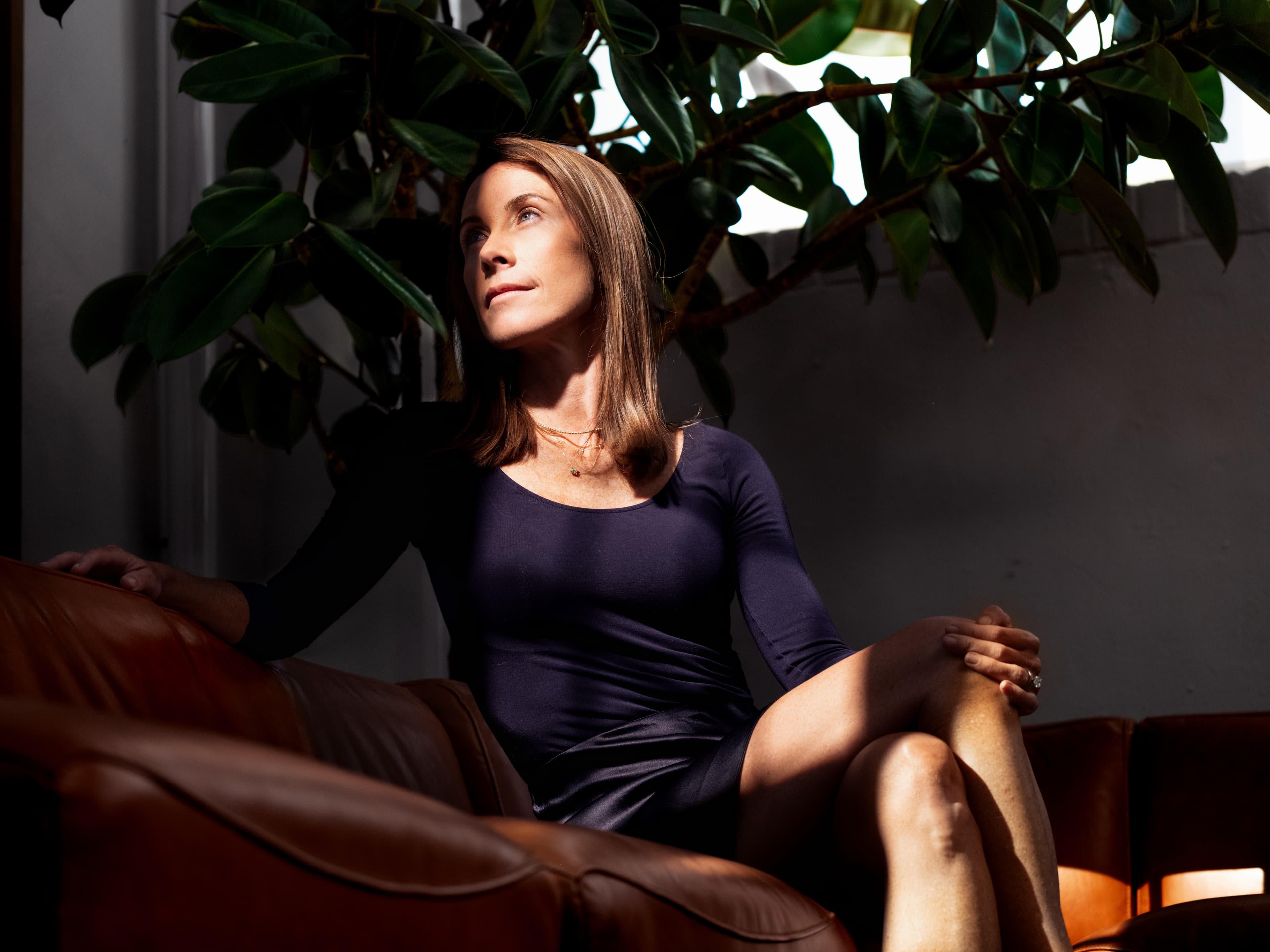 Woman sitting, lit by a nearby window